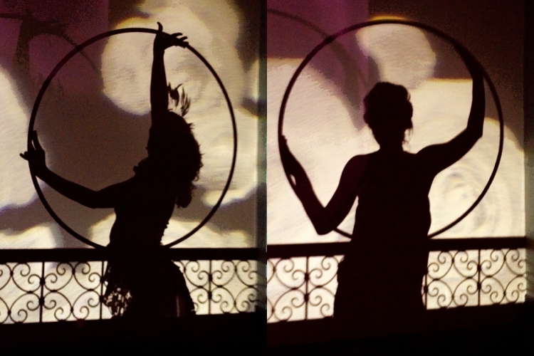 Silhouettes of hula hoopers in costume